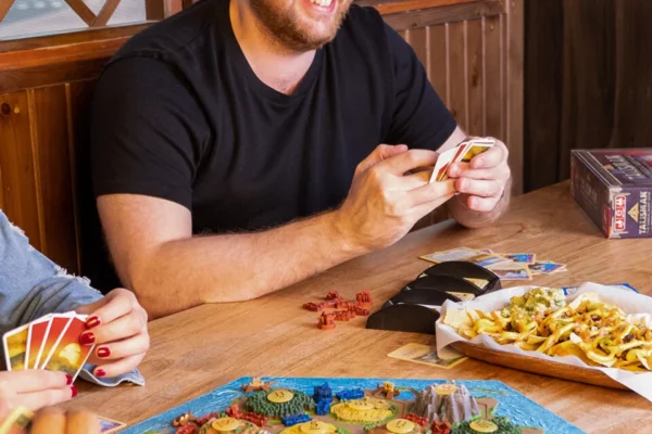 Man-Laughing-At-Board-Game Man-Laughing-At-Board-Game
